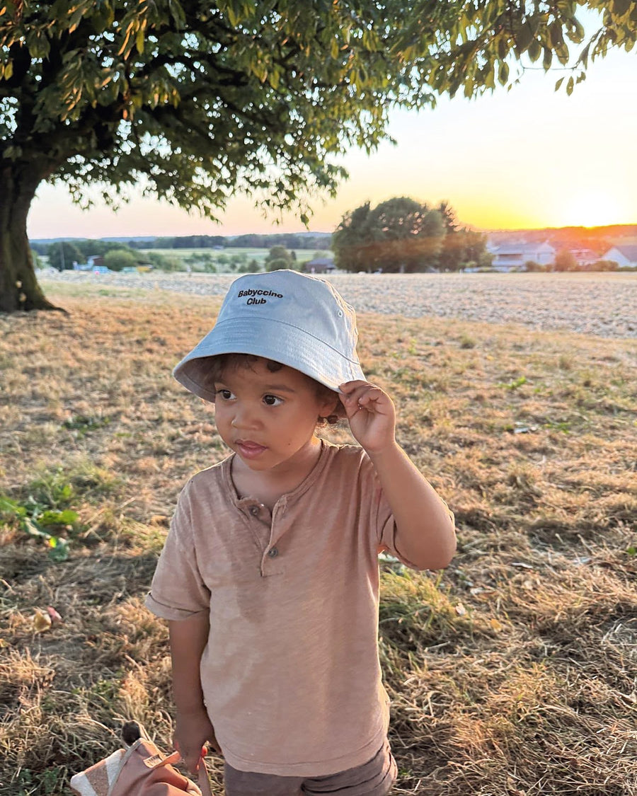 Babyccino Club bucket hat at sunset